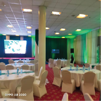 Banquet hall with green lighting and screens