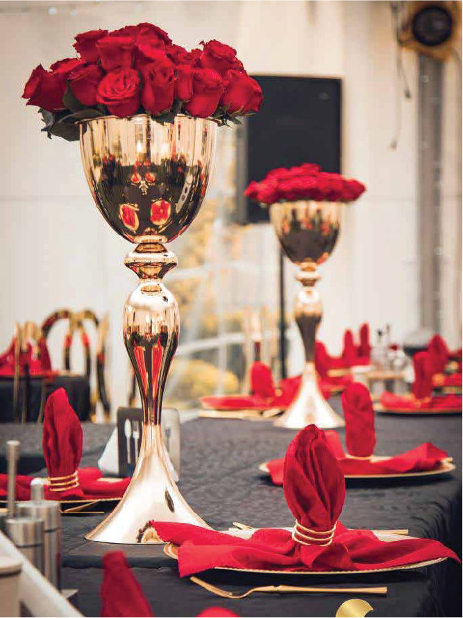 Red floral centrepiece on a gold stand