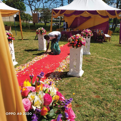 Garden setup with a red carpet and flower arrangements