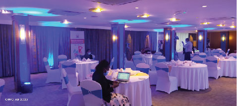 Event hall with purple lighting and dressed tables