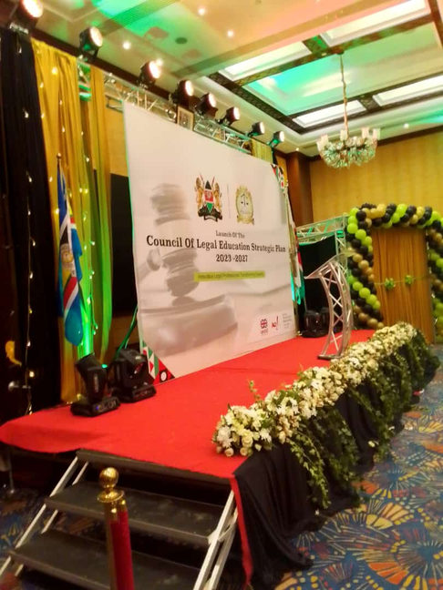 Stage with a red carpet, flowers and the Kenyan flag