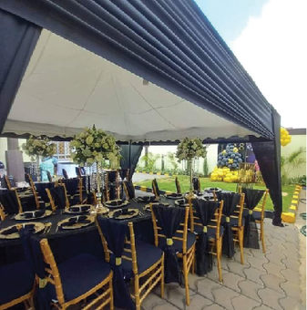 Tent with gold Chiavari chairs and dressed tables
